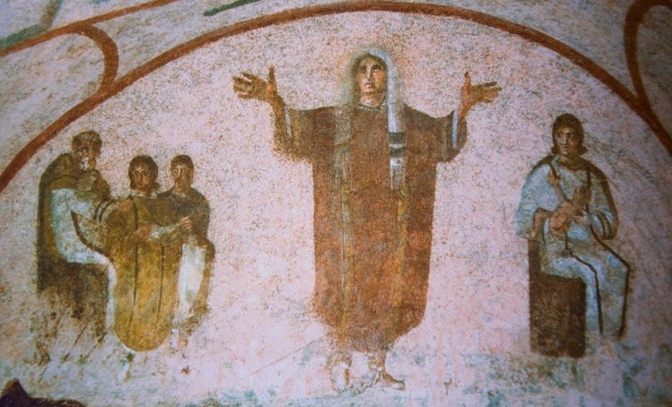 A late 3rd-century "Roman" fresco from the Catacomb of Priscilla depicting a central female figure (the Orant) with arms raised in prayer, flanked by a mother and child on the left and a seated figure on the right.
